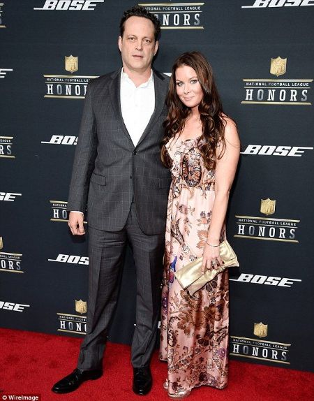 Kyla Weber and her husband Vince Vaughn pose a picture at an event.